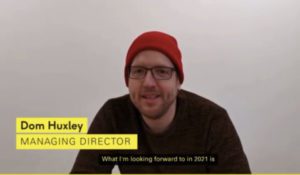 A still from a YouTube video showing a man in a red hat and glasses